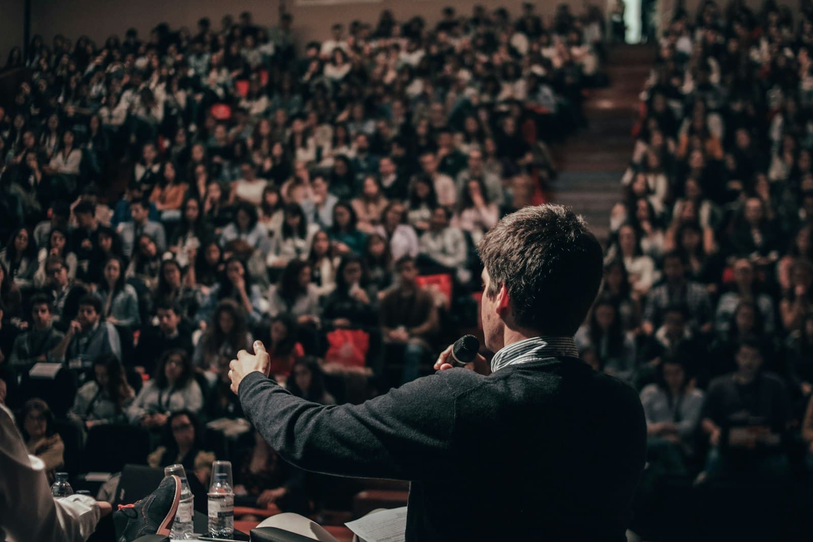 A speaker addressing a full lecture hall